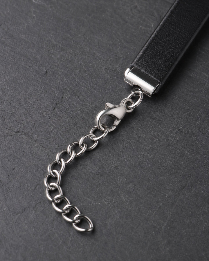 Macro detail of adjustable silver clasp and extension chain